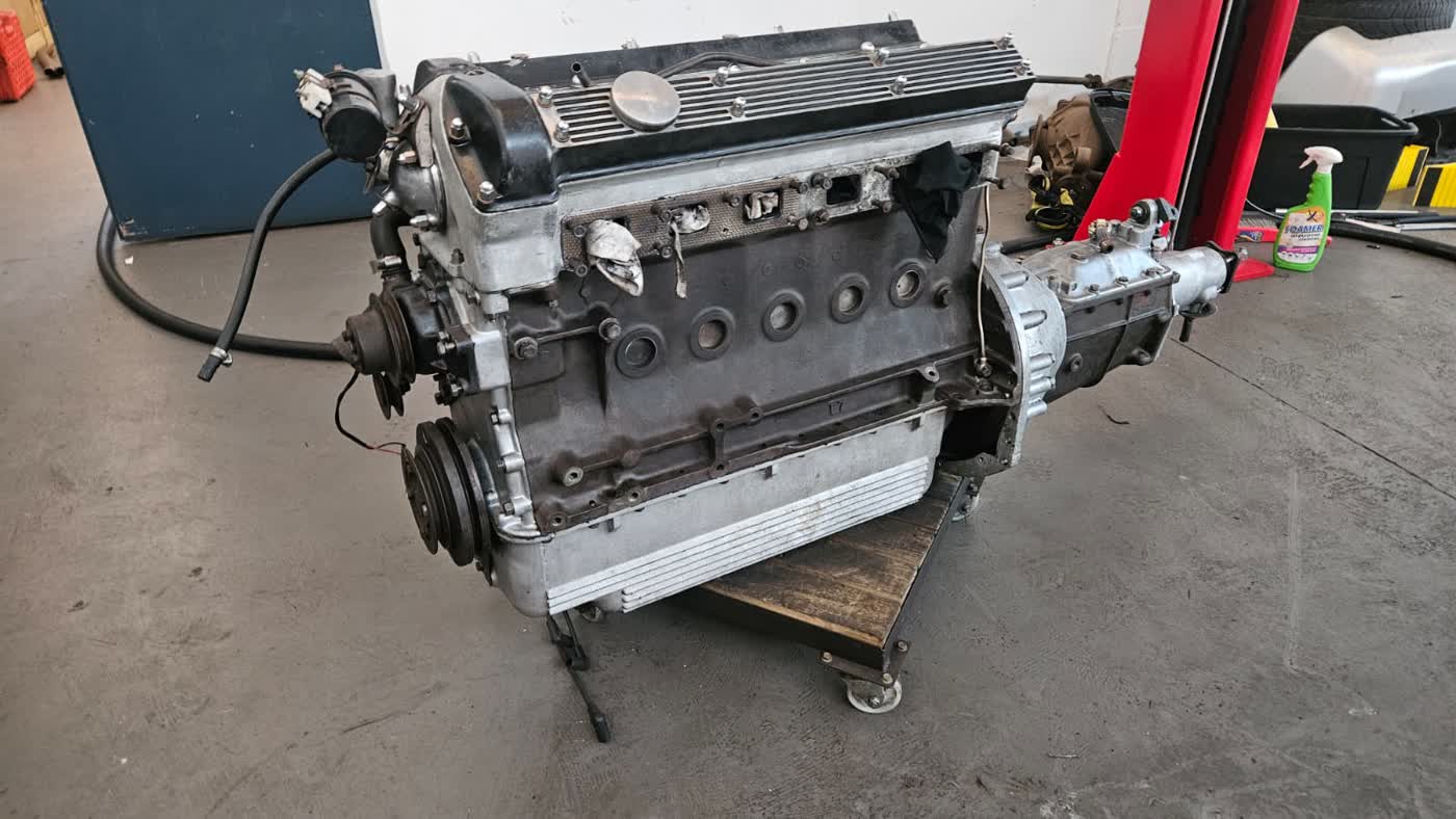 Restored classic Jaguar straight-six engine with polished cam covers after dry ice cleaning
